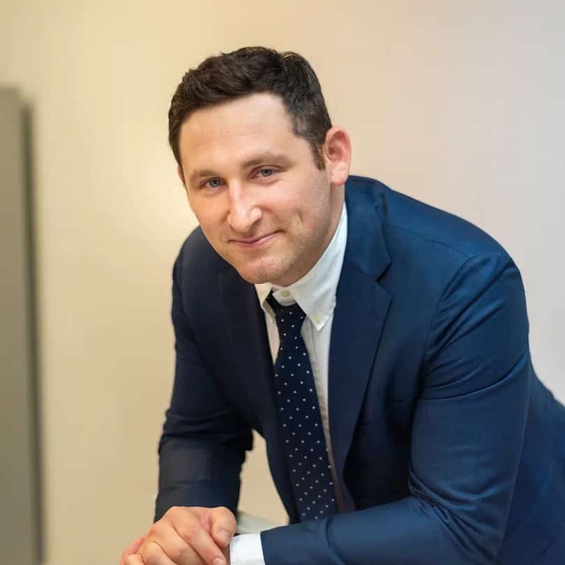 Close-up of doctor and nurse treating injured head of senior man.